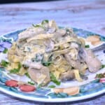 Easy Creamy Chicken and Mushroom Alfredo Served on Blue Plate