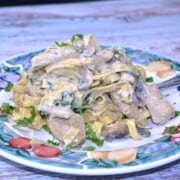 Easy Creamy Chicken and Mushroom Alfredo Served on Blue Plate