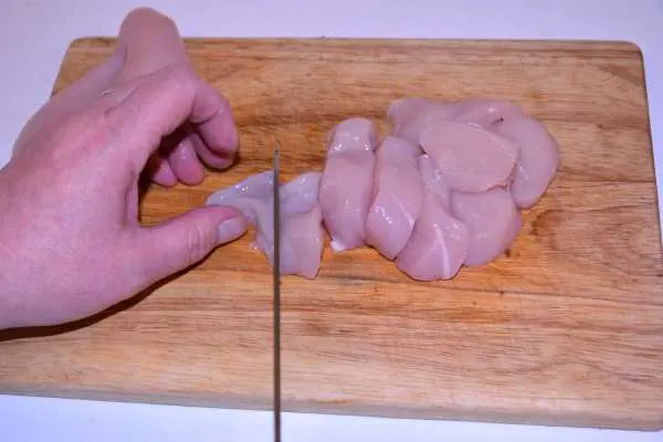 Chicken and Mushroom Alfredo-Slicing Chicken Breast on the Chopping Board