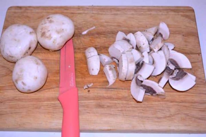 Slicing Mushrooms Slicing White Mushrooms on Cutting Board