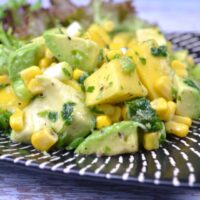 Avocado and Mango Salad-Served on Plate With Lemon Slices and Lettuce Leaves