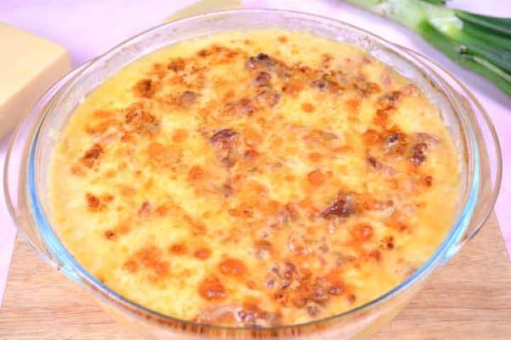 Freshly baked cheesy polenta casserole with a bubbling, golden-brown crust straight out of the oven.