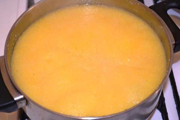 Polenta Thick creamy polenta simmering and bubbling gently in a cooking pot.