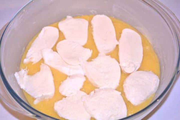 First Layer Mozzarella First layer of warm polenta spread in a glass dish and topped with sliced mozzarella.