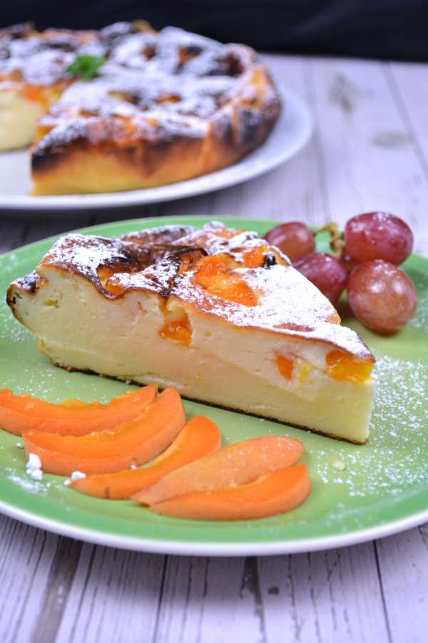 Gluten-Free Yoghurt Cake-Cake Slice Served on Green Plate With Apricot Slices and Red Grapes