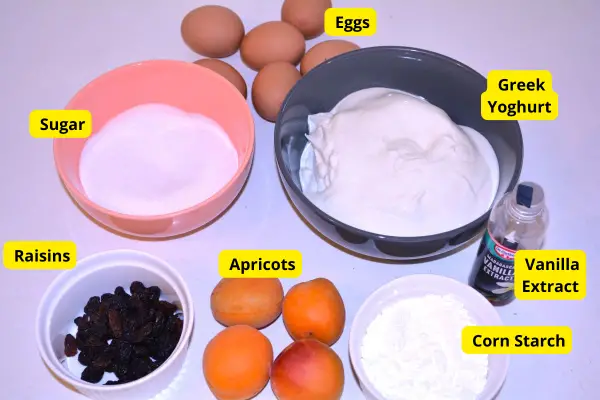 Gluten-Free Yoghurt Cake-Sugar, Eggs, Corn Starch, Greek Yoghurt, vanilla Extract, Raisins and Apricots on the Table