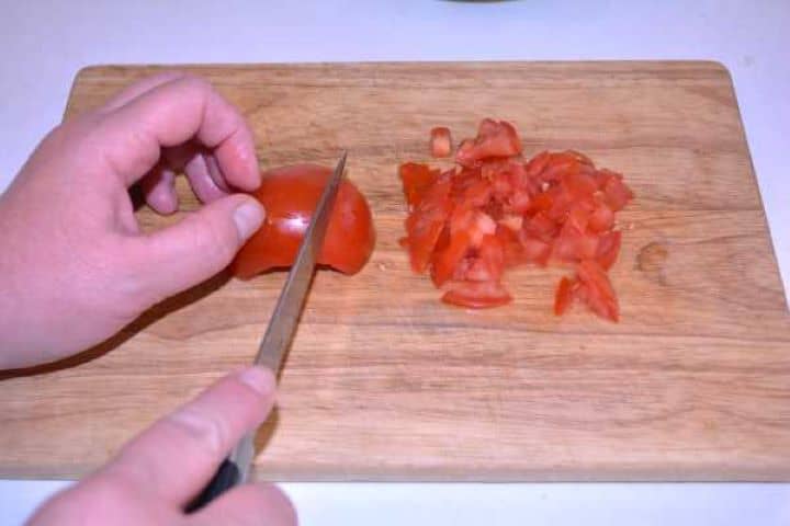 Tomato Diced fresh Roma tomatoes on a cutting board ready for avocado dip.