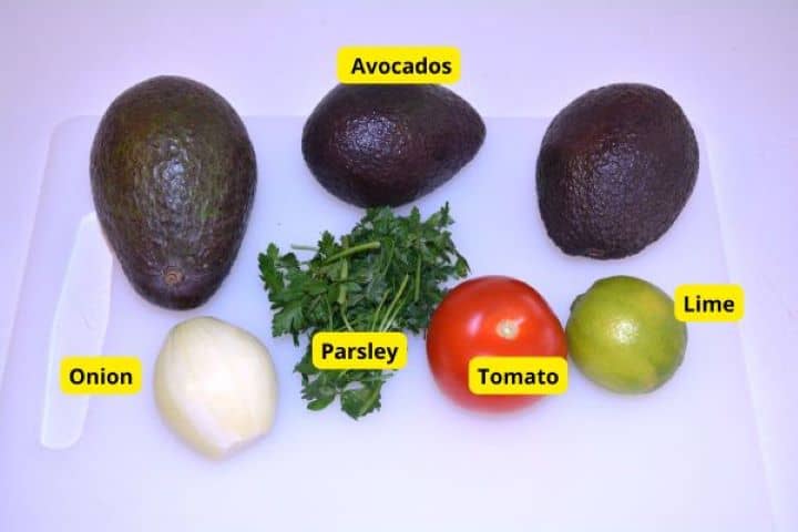 Ingredients Ingredients for cilantro-free guacamole: ripe avocados, onion, tomato, lime, and fresh parsley.