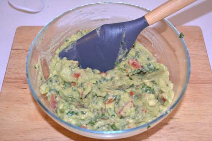 Dip Fresh guacamole with parsley folded together until smooth and well-incorporated.