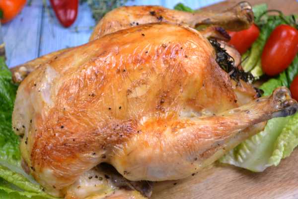 Roasted Free-Range Chicken-Served on Chopping Board With Lettuce Leaves and Cherry Tomatoes