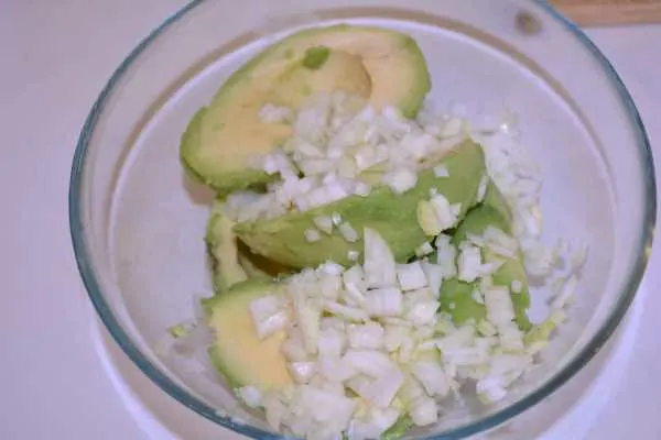 Vegan Guacamole-Avocados Core and Chopped Onion in the Bowl
