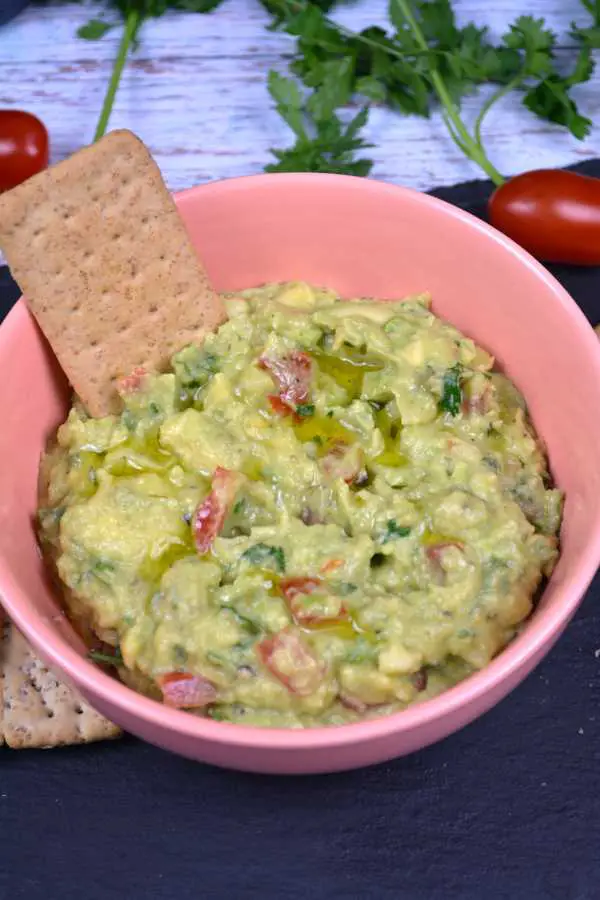 Vegan Guacamole-Served in Pink Bowl With Different Crackers