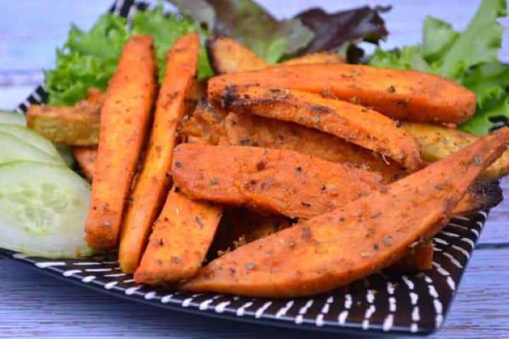 Served Air Fryer Sweet Potato Wedges Served on Black Plate With Fresh Cucumber and Lettuce