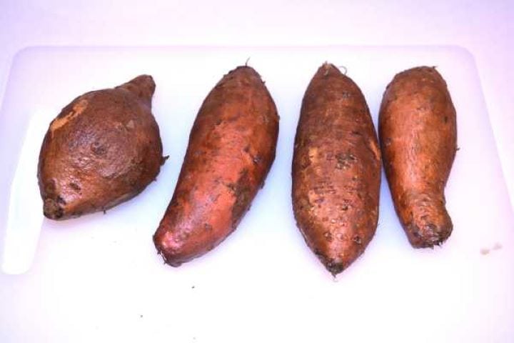 Sweet Potatoes Washed Sweet Potatoes on the Chopping Board