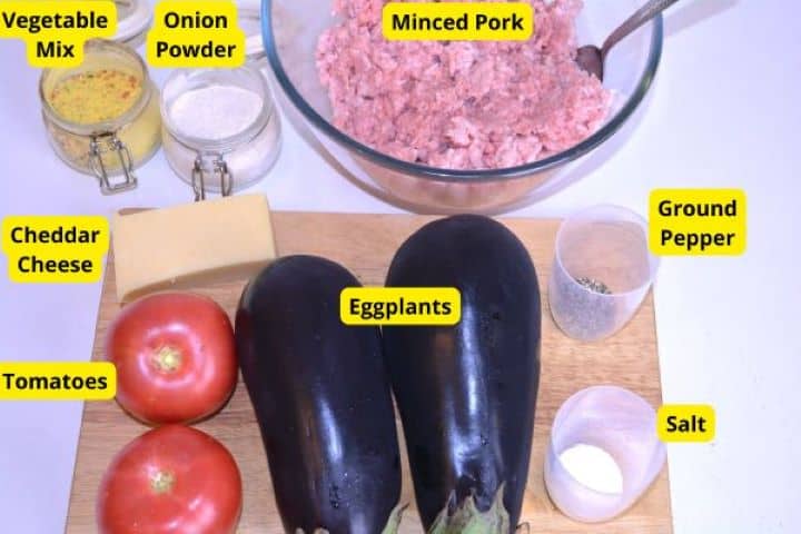 Ingredients Ingredients for baked eggplant with minced pork: fresh eggplants, ripe tomatoes, pork mince, cheddar cheese, and seasonings.