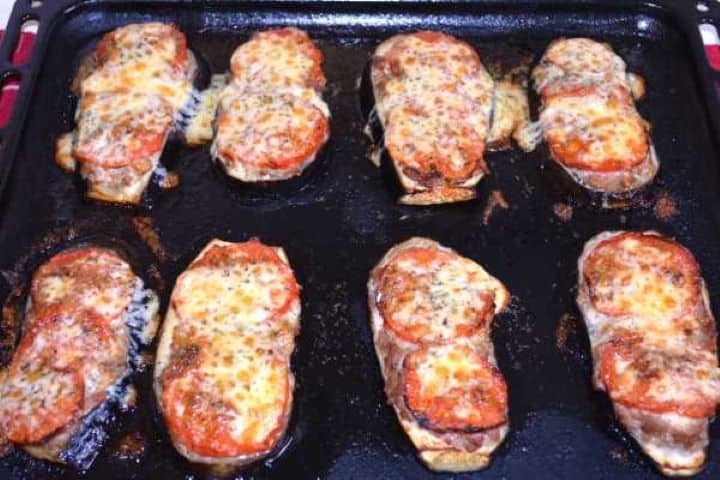Ready Freshly baked eggplant with minced pork and melted, golden bubbly cheddar cheese in the baking tray.