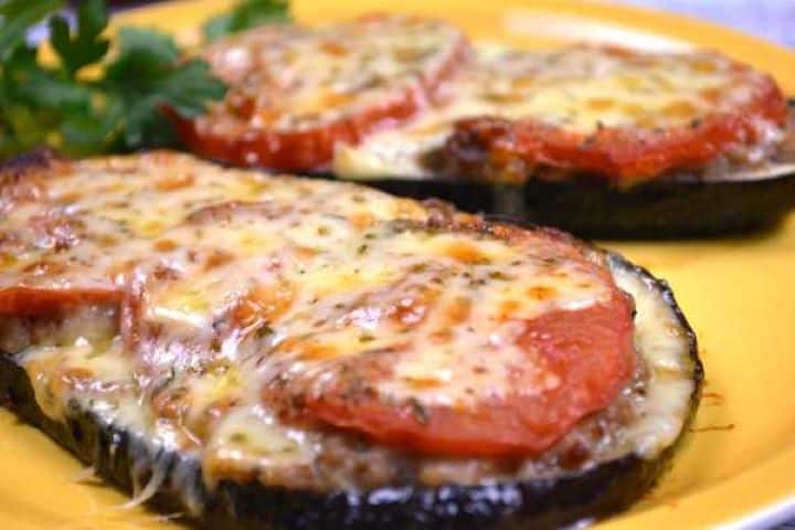 Serving Close-up of layered baked eggplant slice showing juicy seasoned pork mince, roasted tomato, and browned cheese.