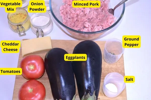 Eggplant With Minced Pork-Two Eggplants, Two Tomatoes, Pork Mince, Cheddar, Onion Powder, Vegetable Mix, Salt and Ground Pepper on the Table