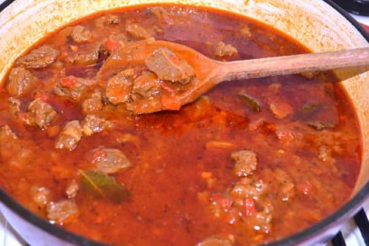 Tender Hungarian beef paprikash with thick glossy sauce ready to serve in a Dutch oven.