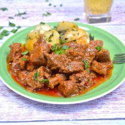 Hungarian Beef Paprikash-Served on Green Plate With Potatoes