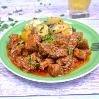 Hungarian Beef Paprikash-Served on Green Plate With Potatoes