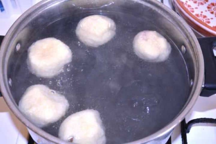 Boil Hungarian plum dumplings simmering gently in a large pot of salted water.