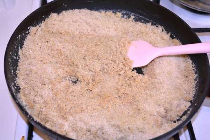 Bread Crumbs Fine breadcrumbs toasting in melted butter until golden-brown in a frying pan.