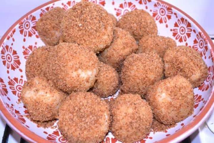 Ready Warm Hungarian plum dumplings coated in golden breadcrumbs served in a large ceramic bowl.