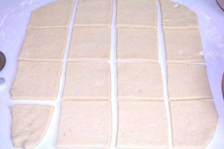 Shapes Potato dough rolled to a quarter-inch thickness and cut into equal squares on a floured surface.