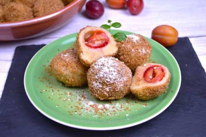 Serve Hungarian plum dumplings served on a green plate.