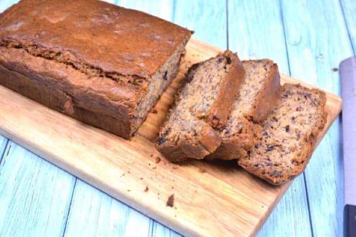 Serve Moist Sugar-Free Banana Bread With Raisins Sliced and Served on the Chopping Board