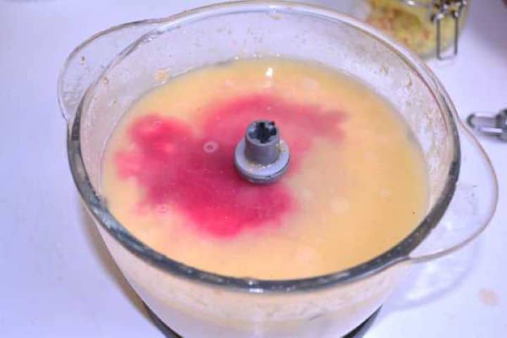 Gelatine Pouring dissolved gelatin broth and fresh beetroot juice over minced chicken in the electric food chopper.