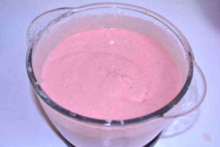 Paste Silky, smooth pink chicken salami paste pureed inside the electric food chopper bowl.