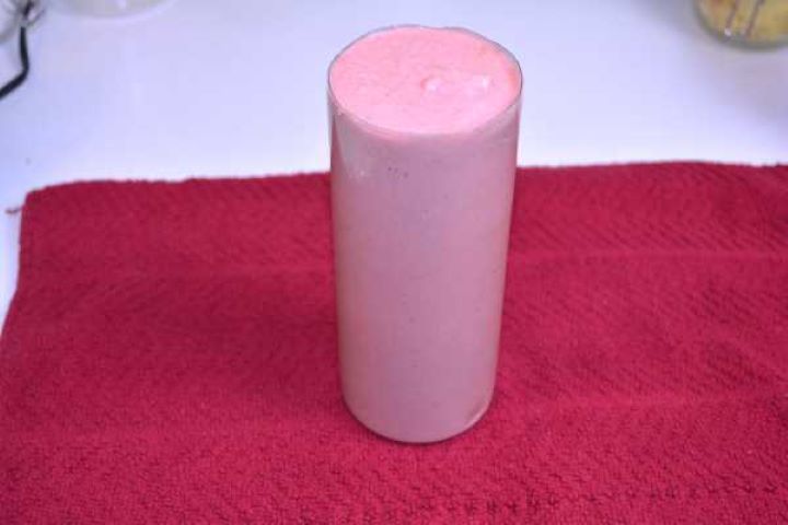 Cooling Pureed chicken salami paste spooned tightly into a trimmed plastic bottle mold for chilling.