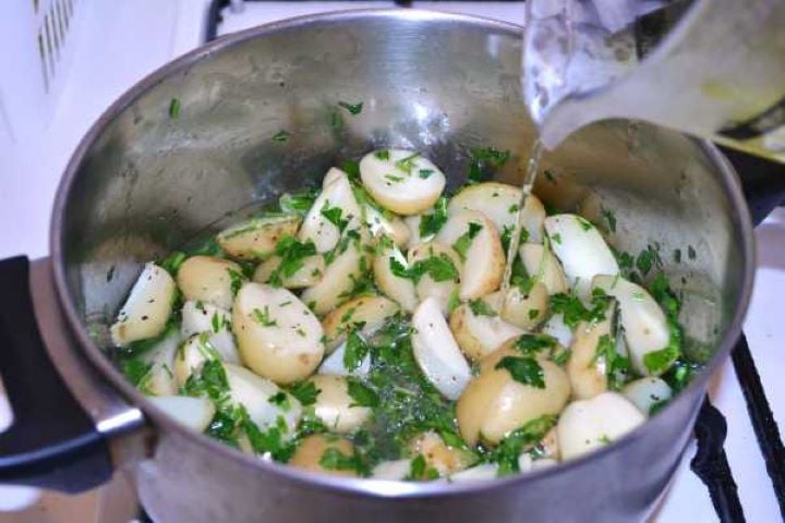 Stock Pouring Water on the Sauteed Potatoes