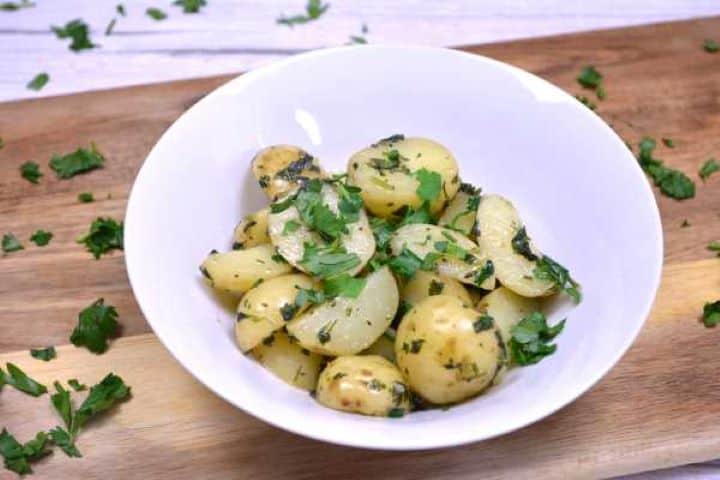 Serve Hungarian Parsley Potatoes Served in the White Bowl With More Chopped Parsley