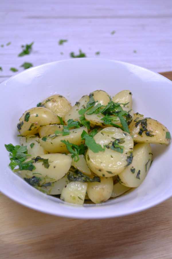 Hungarian Parsley Potatoes-Served in the White Bowl With More Chopped Parsley