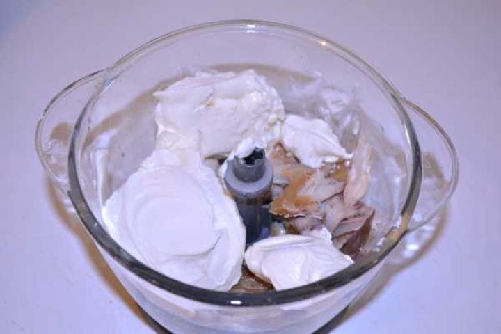 Cheese and Mackerel Softened cream cheese added over smoked mackerel pieces in a food processor bowl.