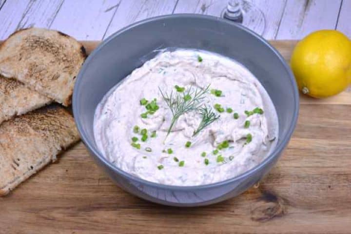 Serve Homemade smoked mackerel pâté in a grey ceramic bowl served alongside crunchy toasted bread.