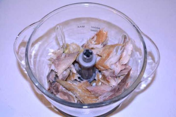 Fish Bites Chunks of skinless and boneless hot-smoked mackerel inside an electric food chopper container.