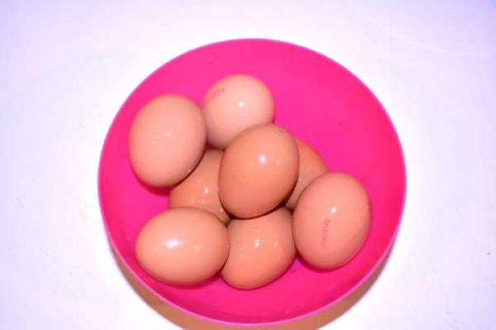 Eggs Eight whole raw free-range eggs in a clear bowl ready to boil for deviled eggs.