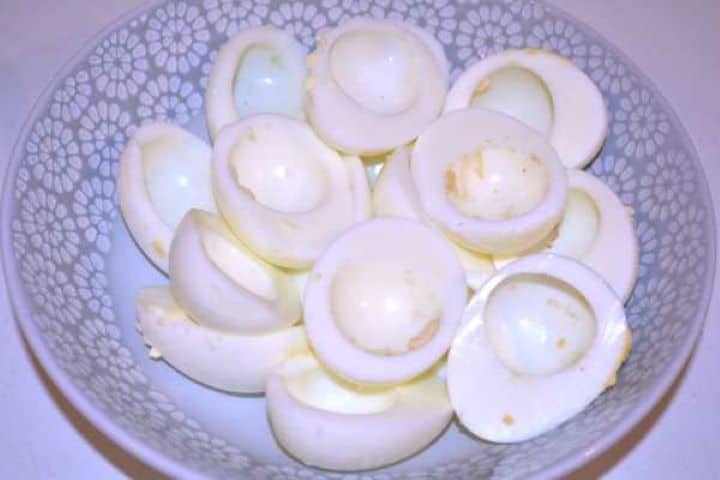 Egg Whites Cleanly peeled hard-boiled egg white halves arranged in a bowl ready to be stuffed.