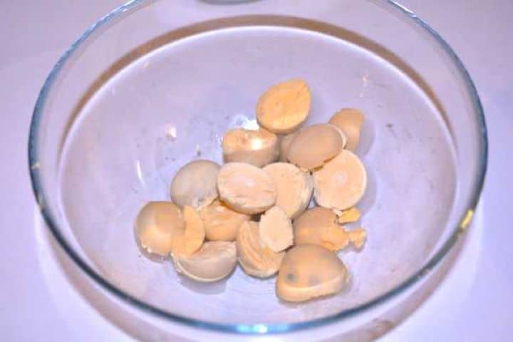 Egg Yolks Separated hard-boiled egg yolks in a glass bowl ready to be mashed for the filling.