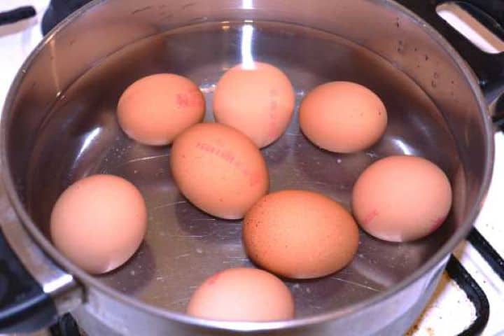 Boil Boiling eight whole eggs in a saucepan of water on medium heat.