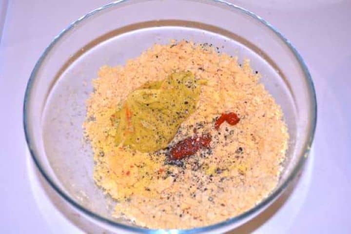 Season Seasoning mashed egg yolks with French mustard, sweet pepper paste, black pepper, and dried vegetable mix.