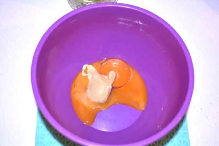 Mayo Raw egg yolks and French mustard in a bowl before emulsifying with oil.