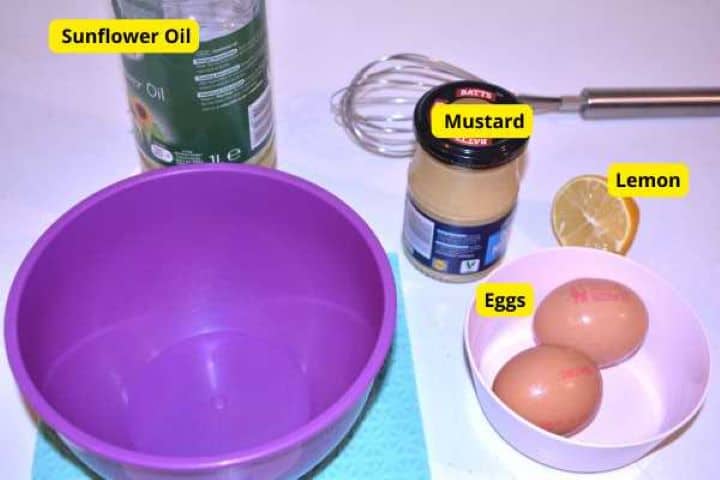 Ingredients Ingredients for homemade mayonnaise and yogurt dill sauce including egg yolks, French mustard, lemon, and sunflower oil.