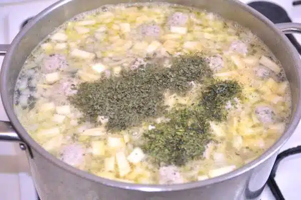 Romanian Meatball Soup-Boiling Soup Seasoned With Dried Lovage and Celery Leaves