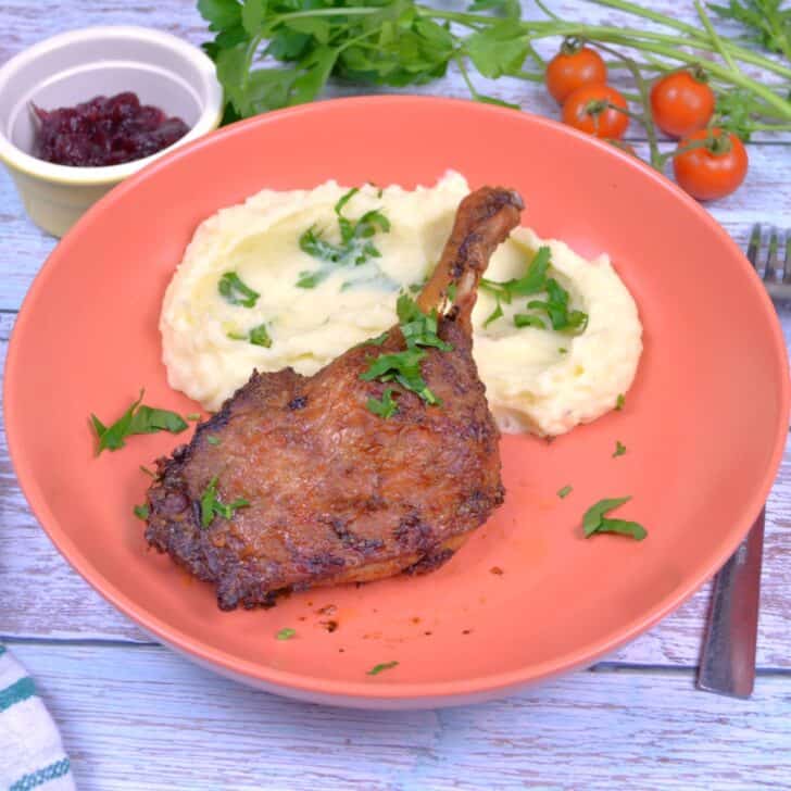 Air Fryer Duck Legs Served on Plate With Mashed Potatoes