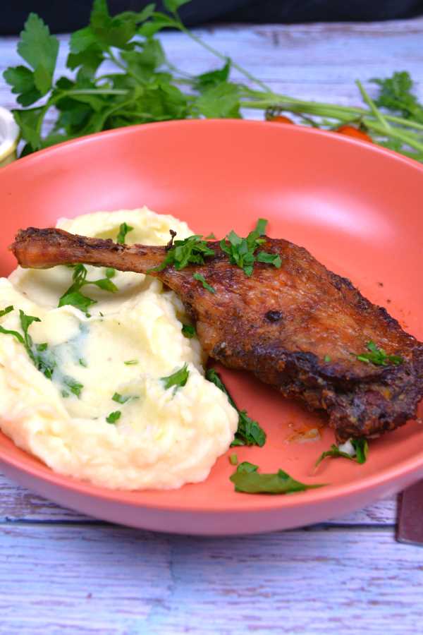Air Fryer Duck Legs-Served on Plate With Mashed Potatoes and Parsley